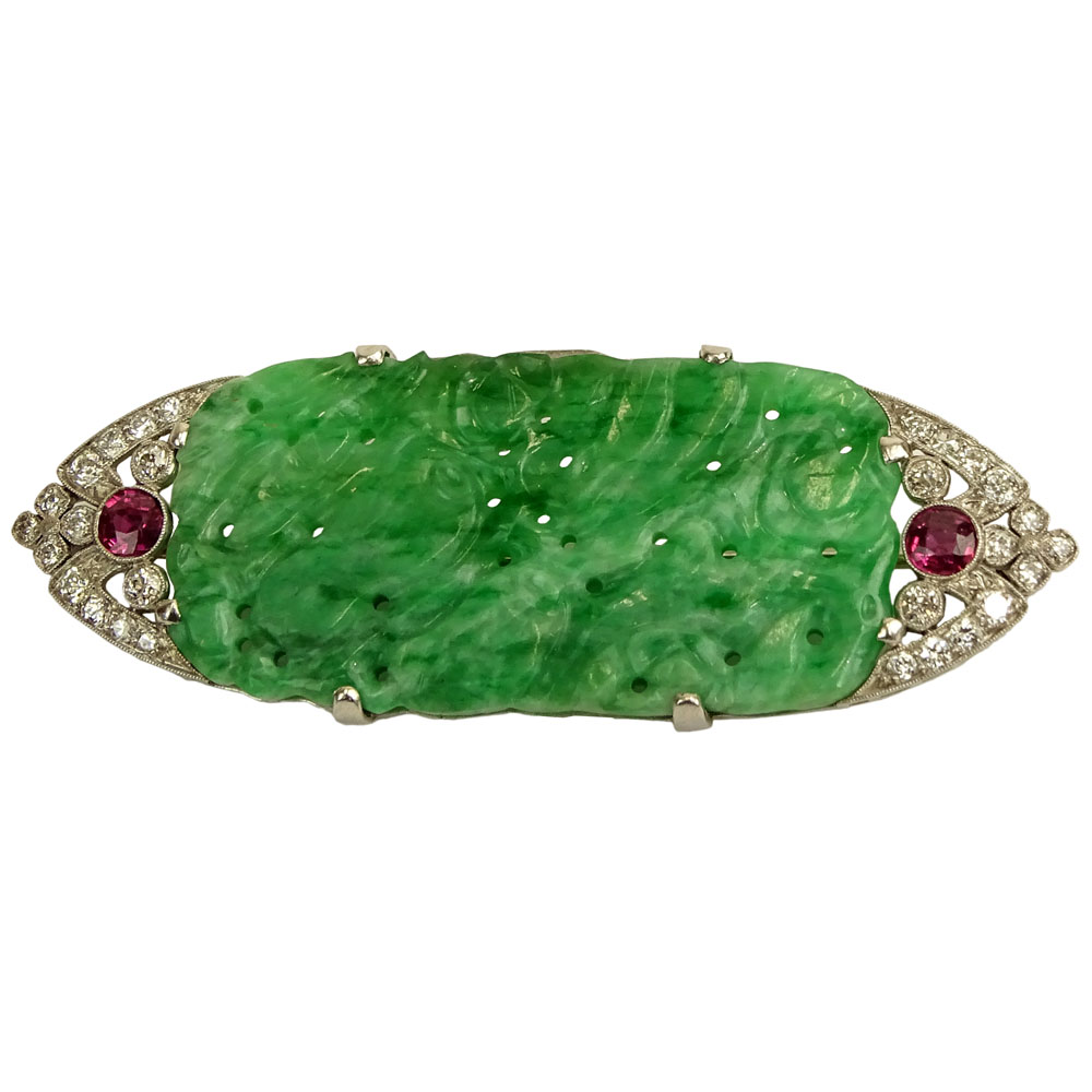 GIA Certified Art Deco Pierced Carved Jade, Round Brilliant Cut Diamond, Ruby and Platinum Brooch. Jade measures 45.23 x 22.87 x 3.80mm. 