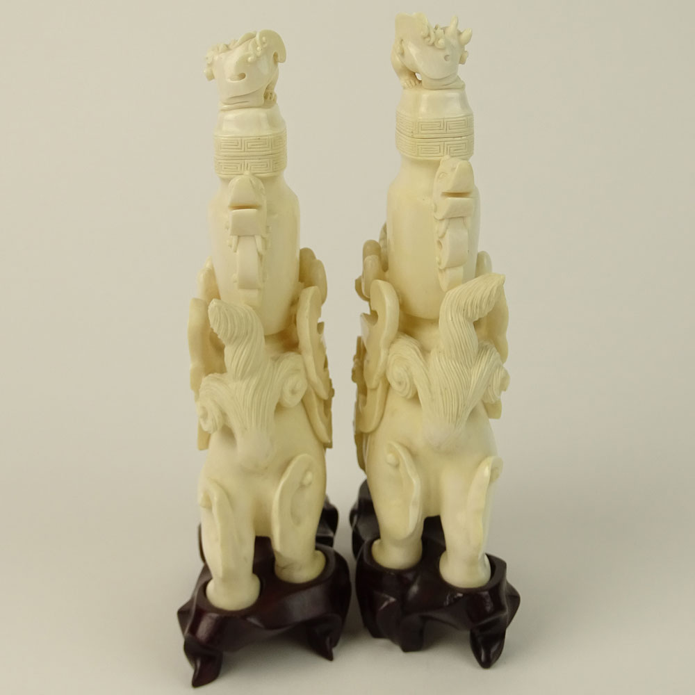 Pair of Vintage well carved Ivory Foo Lion Urns on Hardwood Stands.