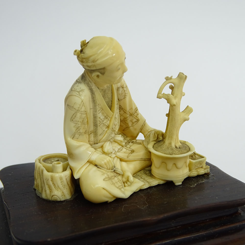 Two (2) Vintage Japanese Carved Ivory Okimono, Seated Man with Bonsai on Wood Base and Water Buffalo and a Japanese Carved Ivory Netsuke Erotic Couple.