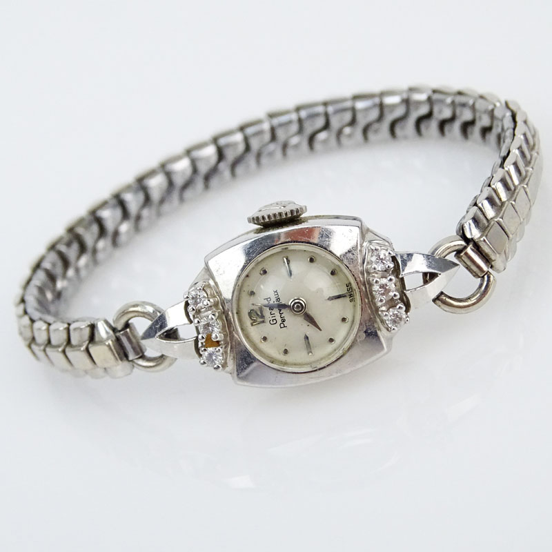 Vintage Lady's Girard Perregaux 14 Karat White Gold Watch with Manual Movement, small diamond accents and white metal bracelet