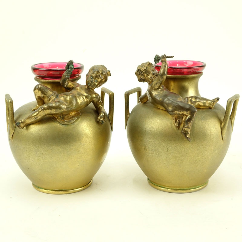 In the Manner of: Aguste Moreau, French (1834-1917) Pair of Art Nouveau Bronze Handle Vases with Cranberry Glass Insert