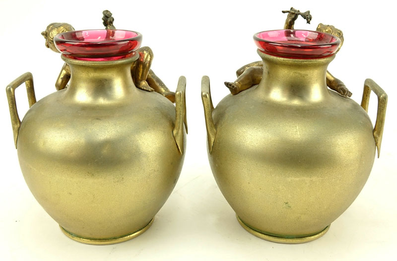 In the Manner of: Aguste Moreau, French (1834-1917) Pair of Art Nouveau Bronze Handle Vases with Cranberry Glass Insert