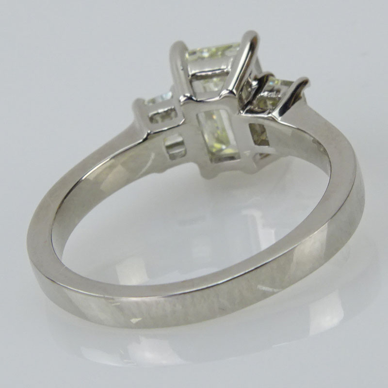 1.92 Carat TW Diamond and Platinum Engagement Ring. Set in the center with an approx. 1.55 carat emerald cut diamond and accented with two .37 carat TW emerald cut diamonds.