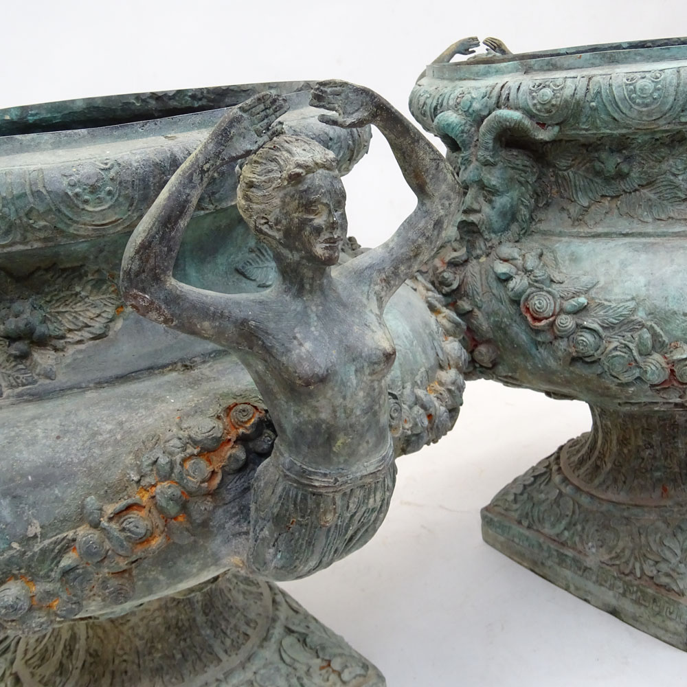 Pair of bronze jardinières with mermaid handles and figural motif.