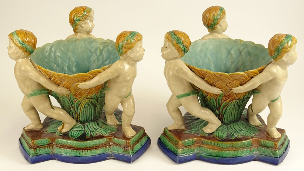 Pair Modern Figural Minton Style Majolica Planters. Each depicts three cherubs.