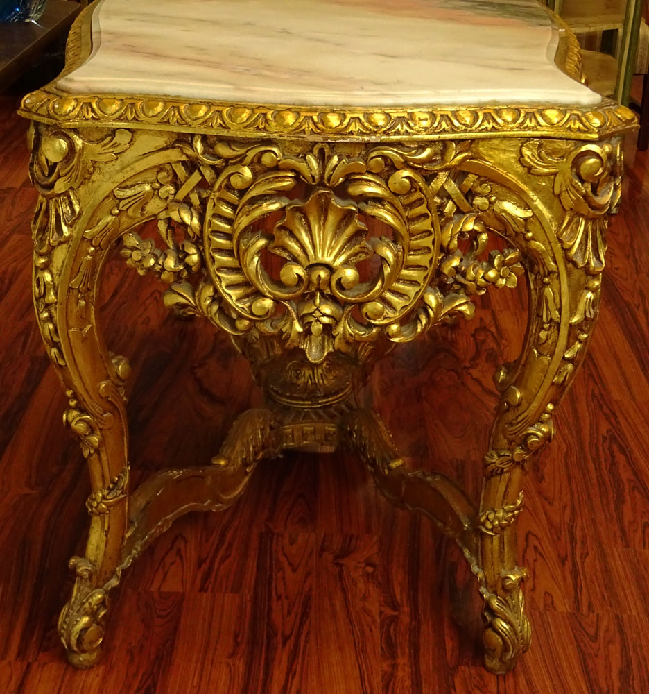 Large Rococo Style Carved and Giltwood Center Table with Marble top.