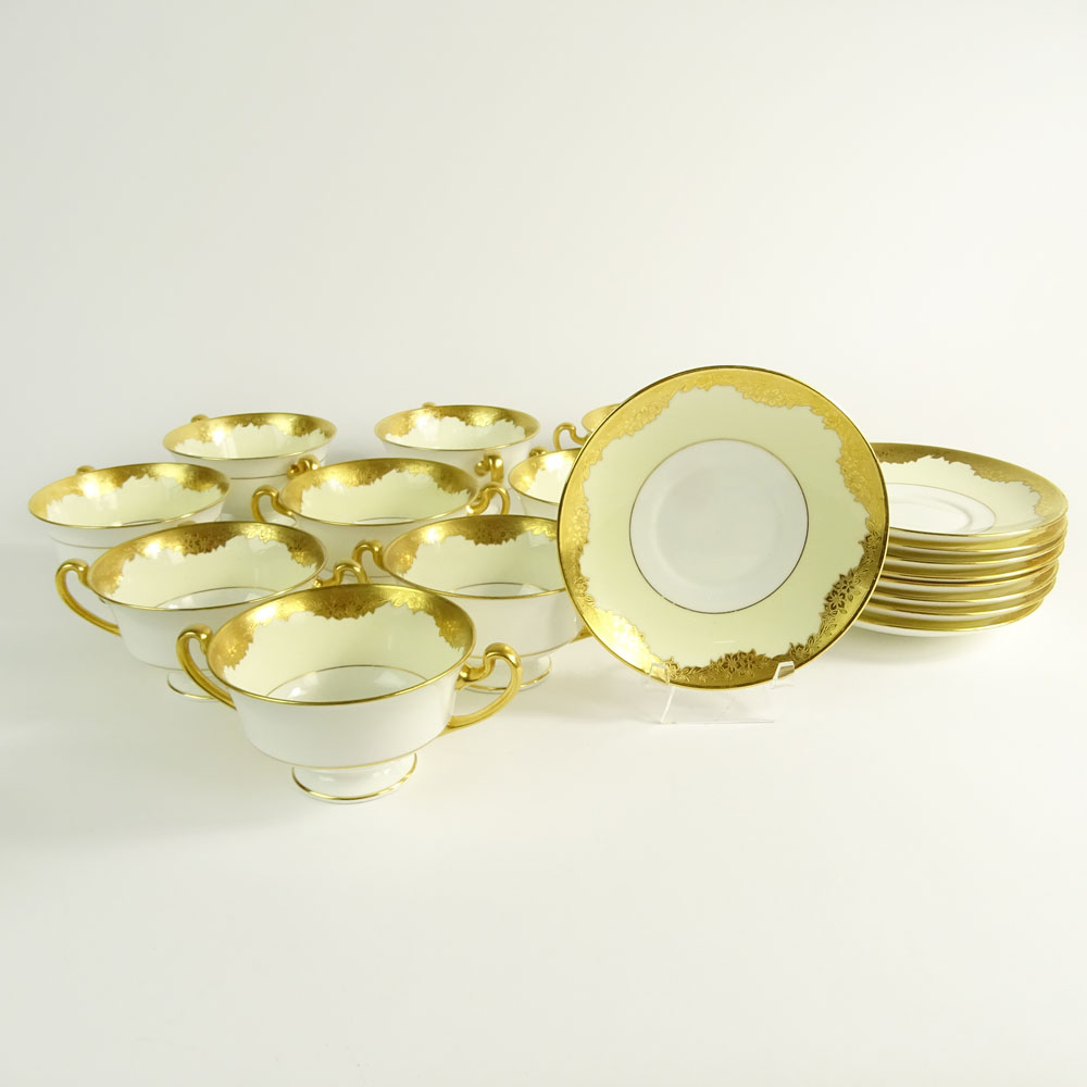 Lot of 9 Minton porcelain and gilt cream soup cups and saucers.