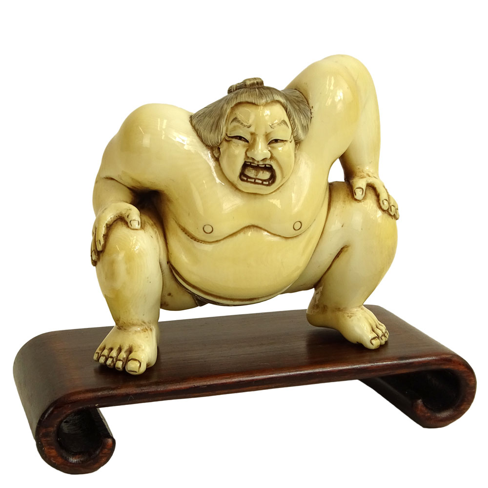 Vintage Japanese Carved Ivory Figure of a Sumo Wrestler on hardwood stand.