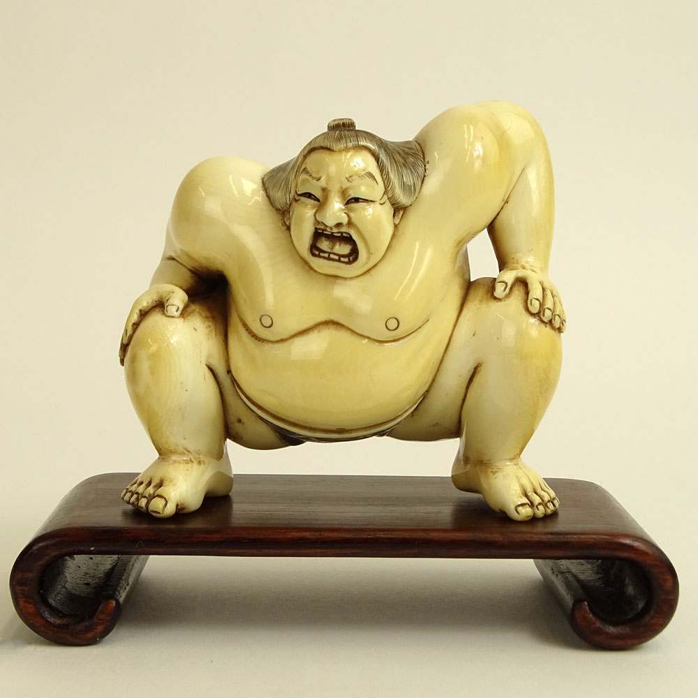Vintage Japanese Carved Ivory Figure of a Sumo Wrestler on hardwood stand.