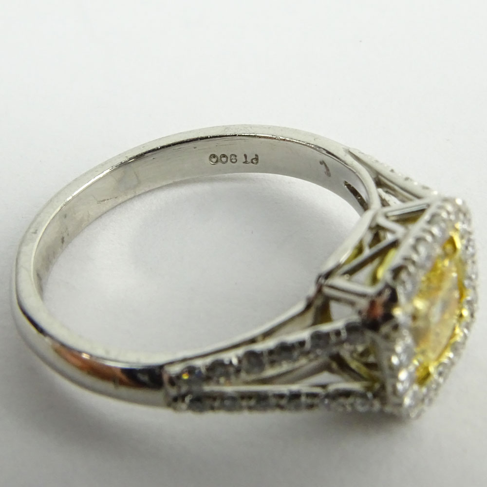 1.01 Radiant Cut Fancy Yellow Diamond, Platinum and 18 Karat yellow Gold Engagement Ring.