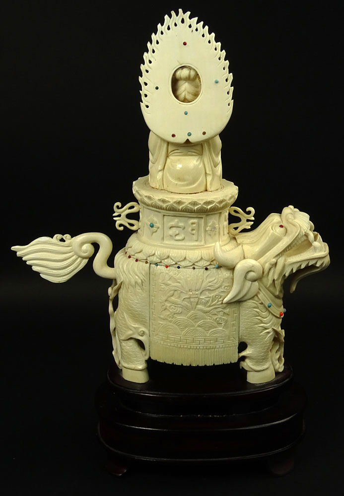 Vintage Chinese Carved Ivory on Hardwood Stand "Deity On Foo Lion" Inset with turquoise and coral beads. 