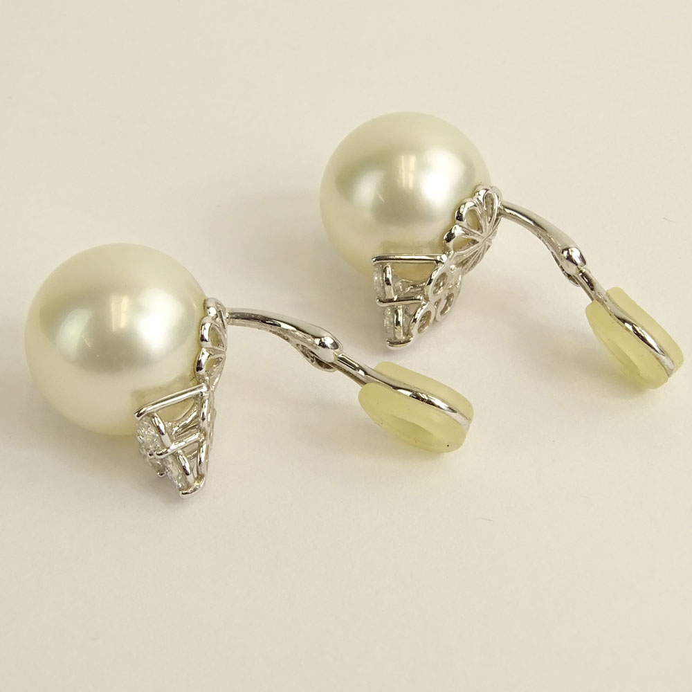 Pair of 15.6-15.9mm South Sea Pearl and 18 Karat White Gold Earclips with Three (3) Round Brilliant Cut Diamonds.