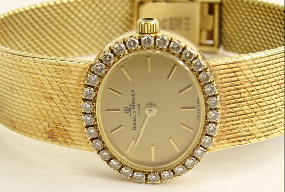 Lady's Vintage Baume & Mercier 14 Karat Yellow Gold Bracelet Watch with Diamond Bezel.