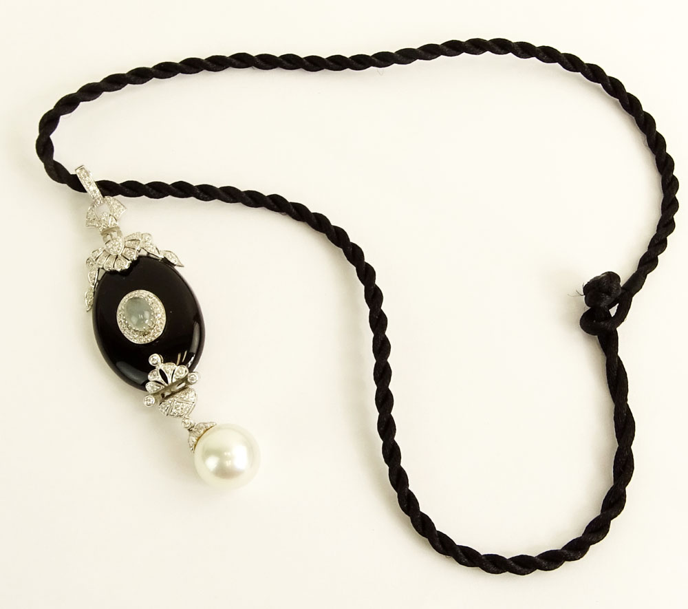 Modern Art Deco style South Sea Pearl, Black Onyx, 18 Karat White Gold Pendant accented with small round cut diamonds. 