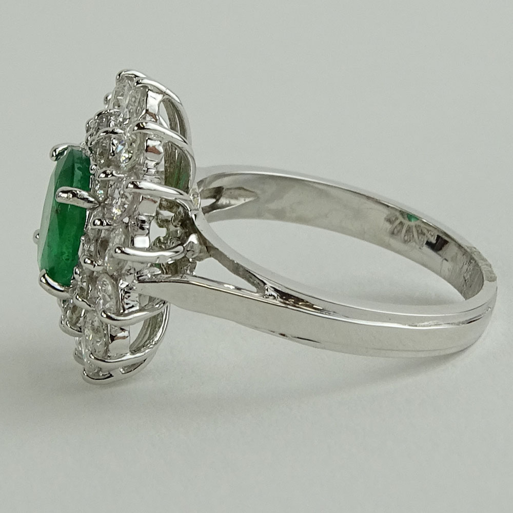 Lady's 1.60 Carat Oval Cut Emerald, 1.45 Carat Round Cut Diamond and 14 Karat White Gold Ring. 