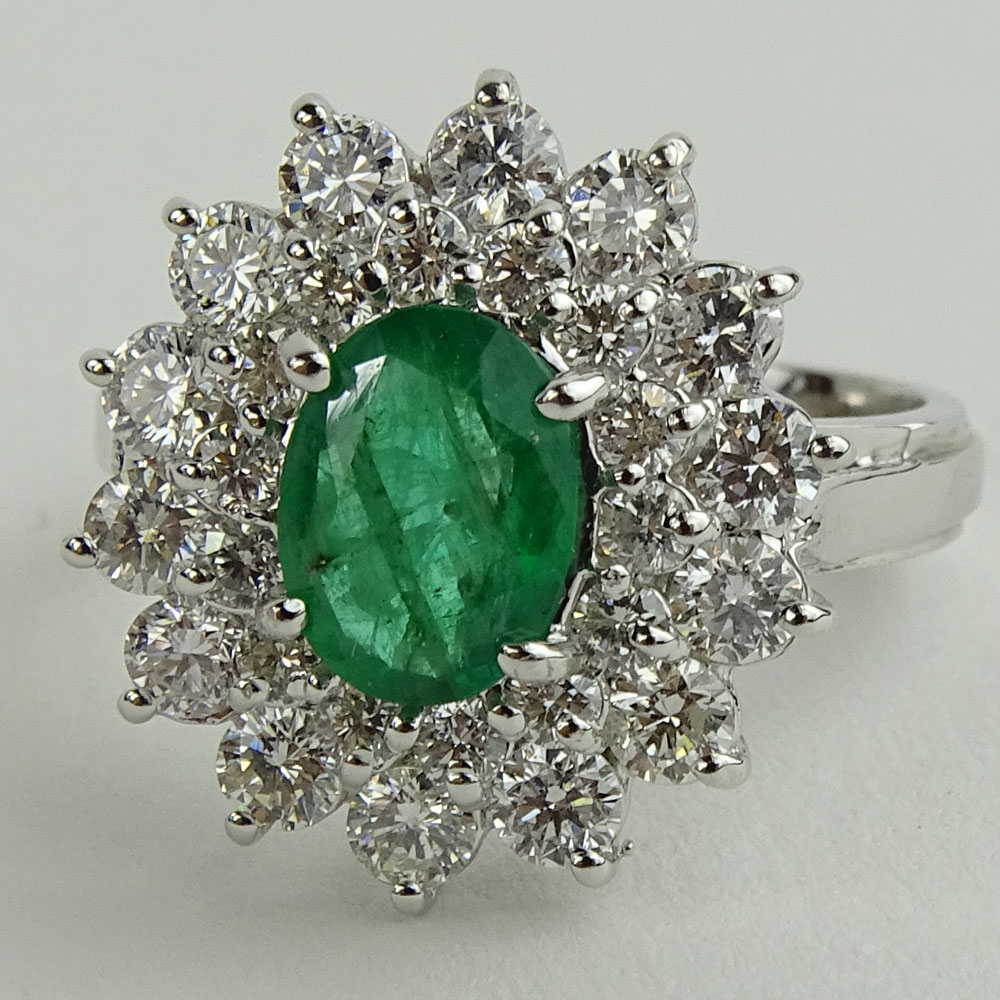 Lady's 1.60 Carat Oval Cut Emerald, 1.45 Carat Round Cut Diamond and 14 Karat White Gold Ring. 
