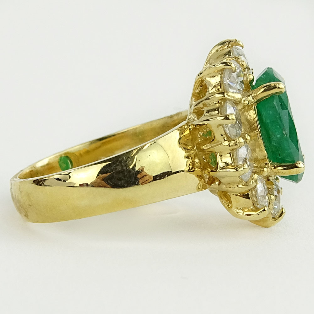 Lady's 4.00 Carat Oval Cut Emerald, 1.80 Carat Round Cut Diamond and 14 Karat Yellow Gold Ring. 