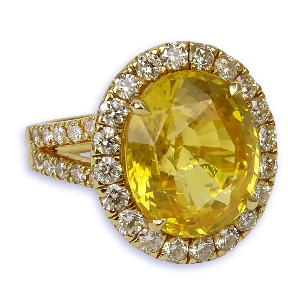 GIA Certified 12.65 Carat Oval Cut Yellow Sapphire and 18 Karat Yellow Gold Ring accented throughout with Round Brilliant Cut Diamonds