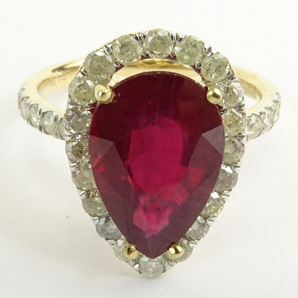GGA Certified 5.61 Carat Pear Shape Ruby and 14 Karat Yellow Gold Ring Accented with 1.09 Carat Round Brilliant Cut Diamonds.