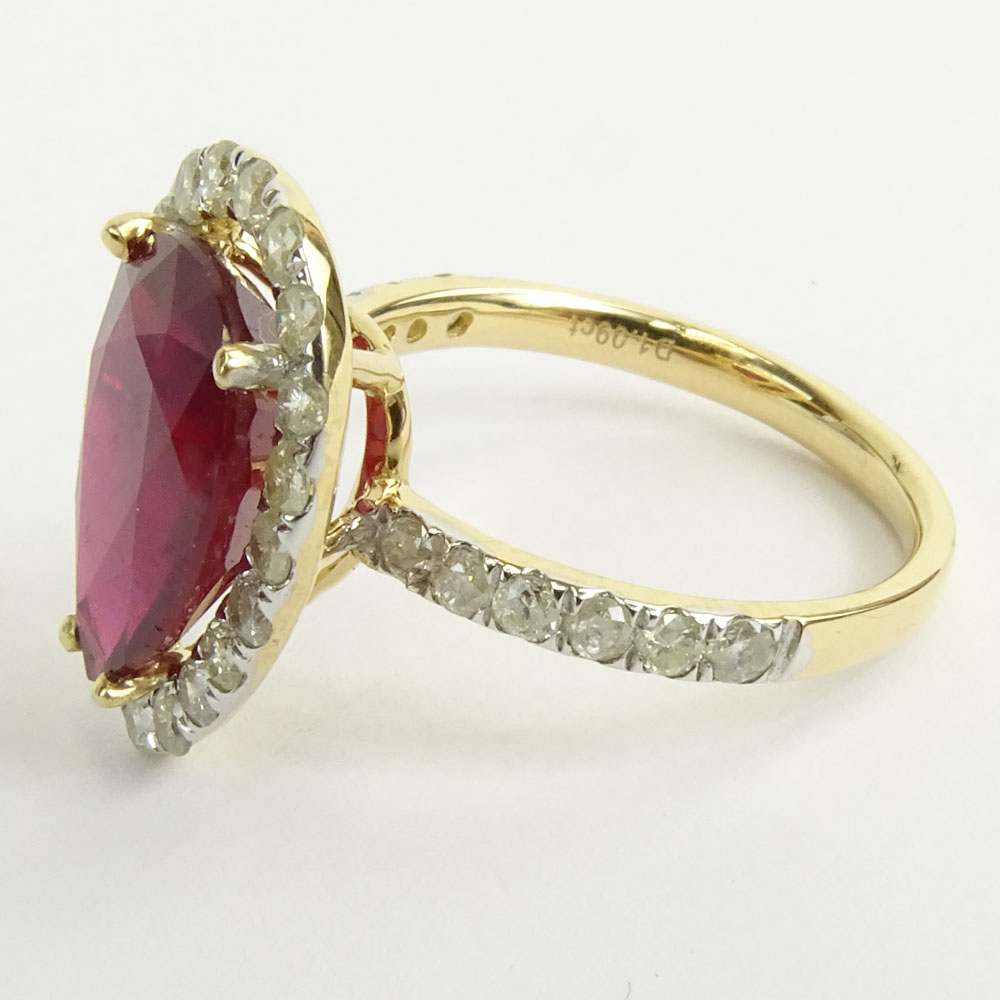 GGA Certified 5.61 Carat Pear Shape Ruby and 14 Karat Yellow Gold Ring Accented with 1.09 Carat Round Brilliant Cut Diamonds.