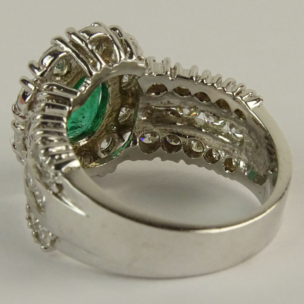 Lady's Oval Cut Emerald,  Round Brilliant Cut Diamond and 14 Karat White Gold Ring. 