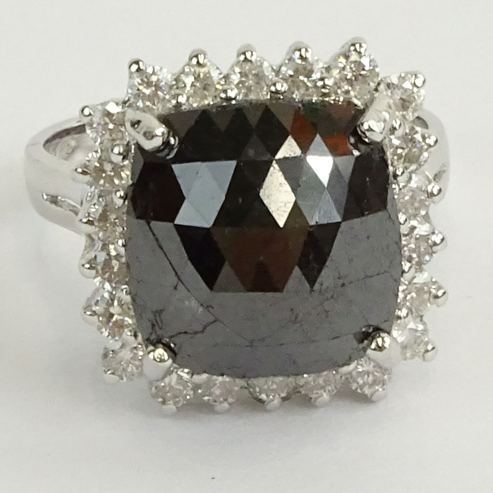 AIG Certified 7.22 Carat Cushion Cut Black Diamond and 14 Karat White Gold Ring accented with .69 Carat Round Brilliant Cut Diamonds.