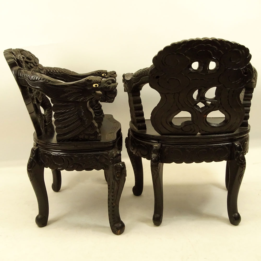 Pair of 20th Century Chinese Carved Wood Dragon Arm Chairs. Inset eyes.