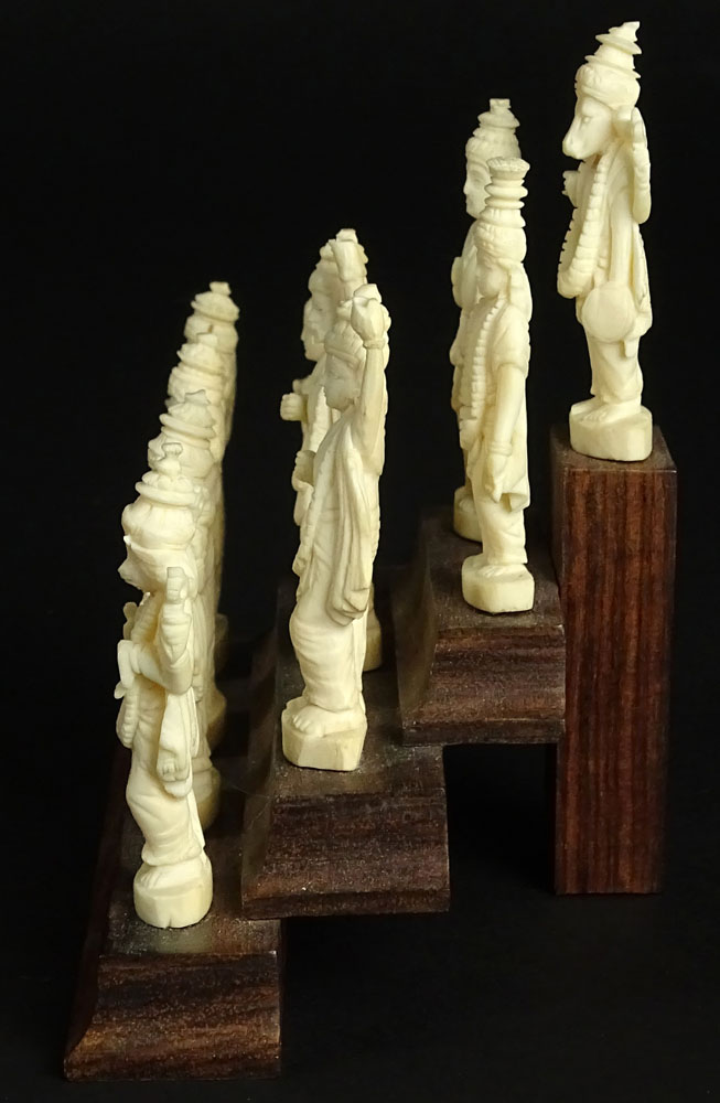 Ten (10) Indian Carved Ivory Deity Figures on Stepped Wood Base.