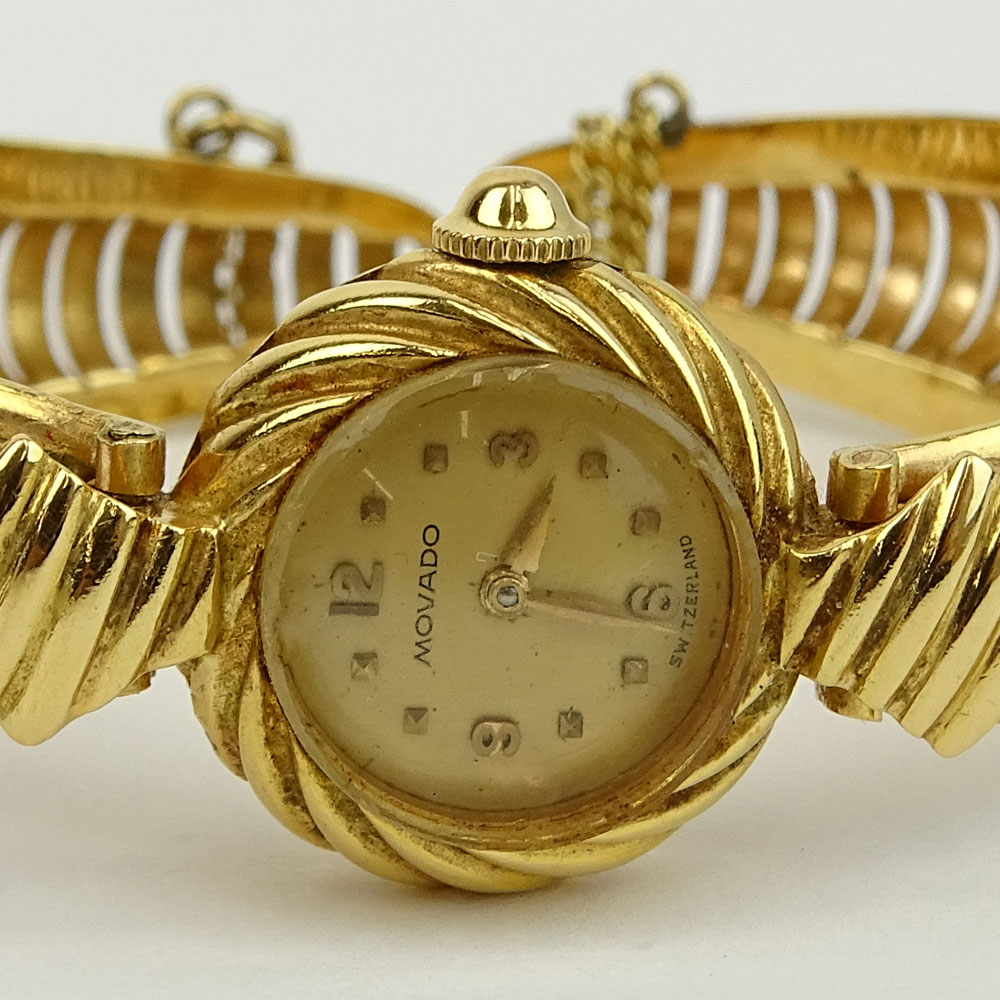 Lady's Vintage 14 Karat Yellow Gold Movado Bangle Bracelet Watch with Manual Movement.