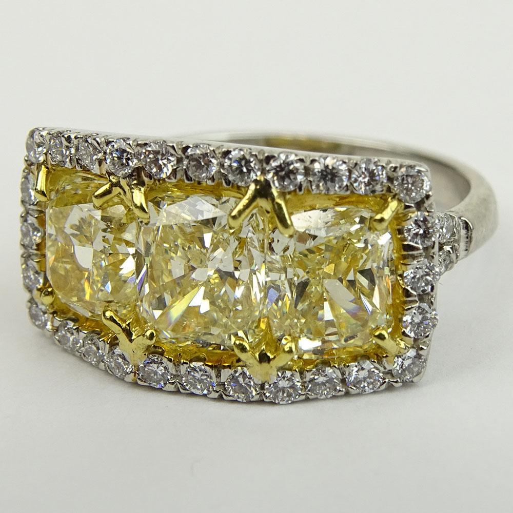 Fancy Yellow Diamond and Platinum Three Stone Ring Set with Three (3) Cushion Cut Diamonds