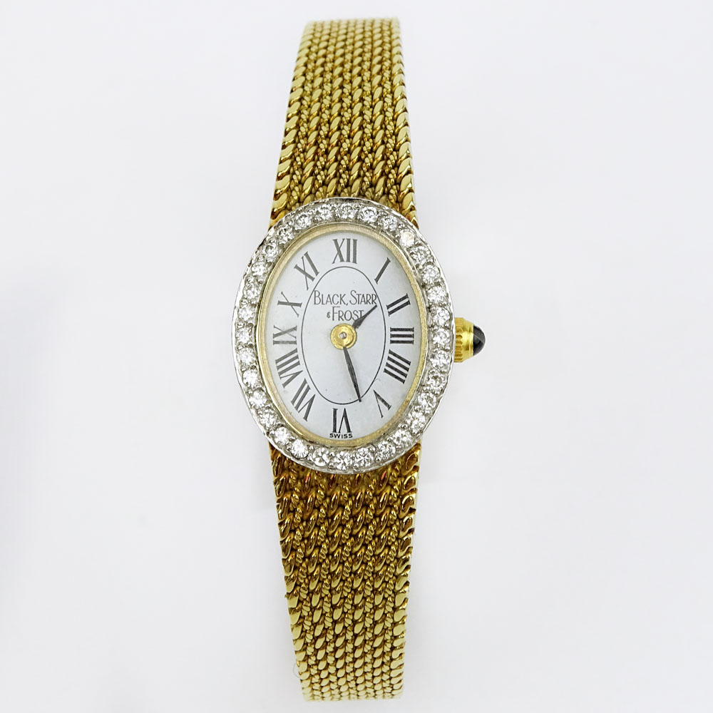 Lady's Black Starr & Frost 14 Karat Yellow Gold Bracelet Watch with Round Brilliant Cut Diamond Bezel. Quartz movement.