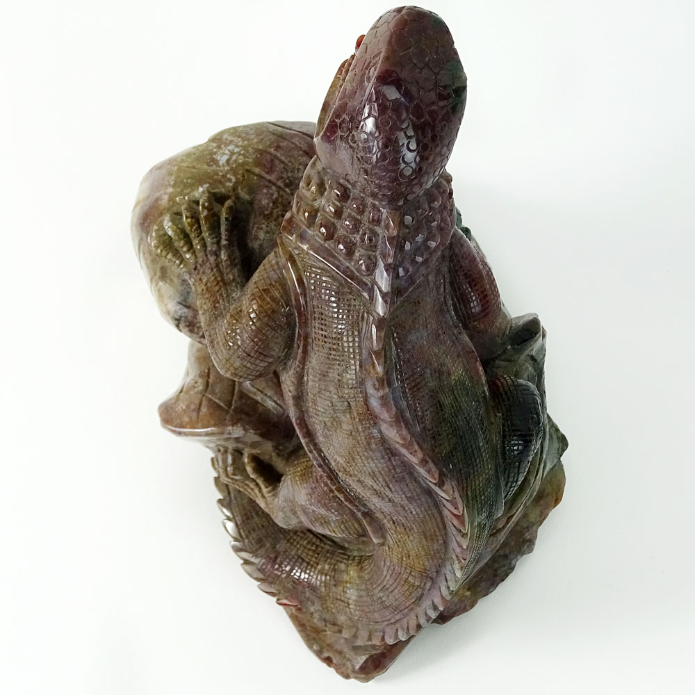 Carved Rhodonite Iguana Figure. With forked tongue perched on a limb.