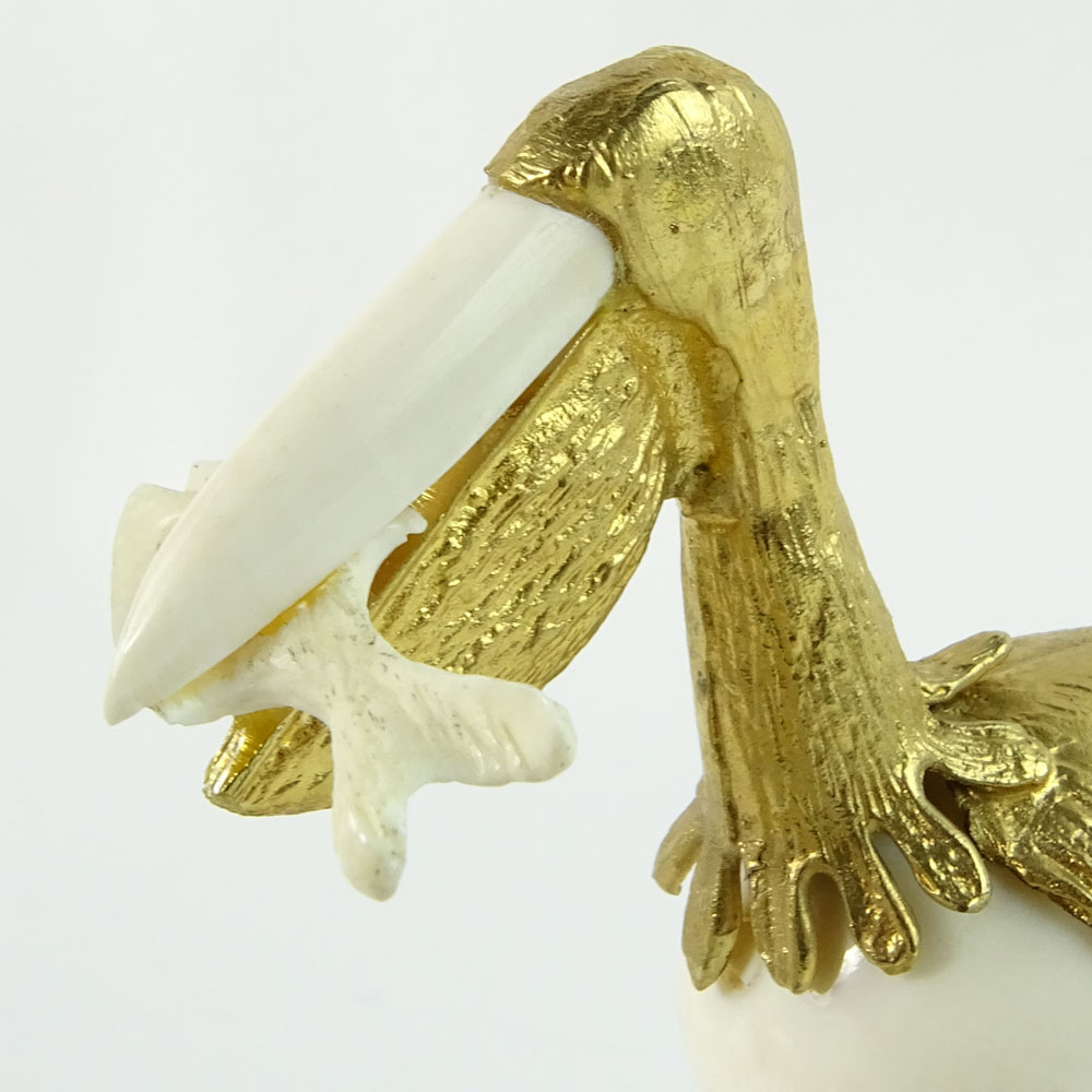 Boxed set of Ivory and 18K Gilt Metal Exotic Bird Figurines. Each bird hand carved and mounted in 18K gold plated metal.