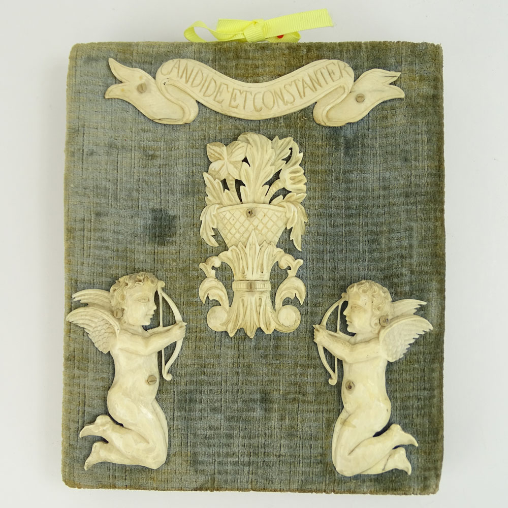 Early Carved Ivory Motto Plaque on Fabric Covered Board.