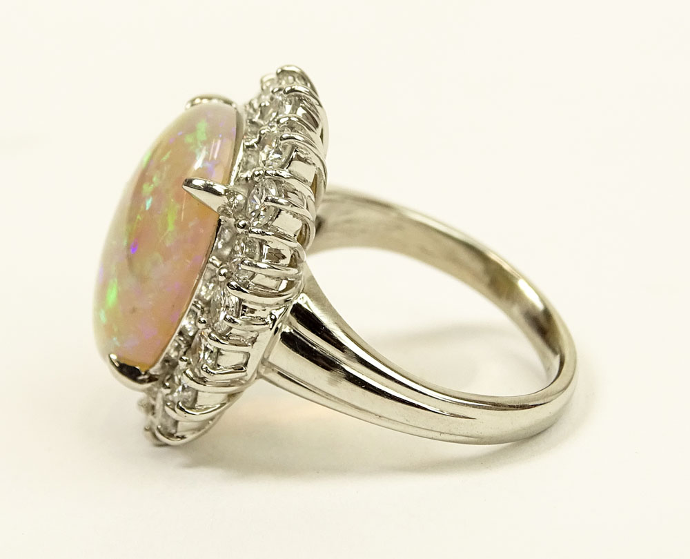 Lady's Oval Cut White Opal, Approx. 1.0 Carat Round Brilliant Cut Diamond and Platinum Ring. 