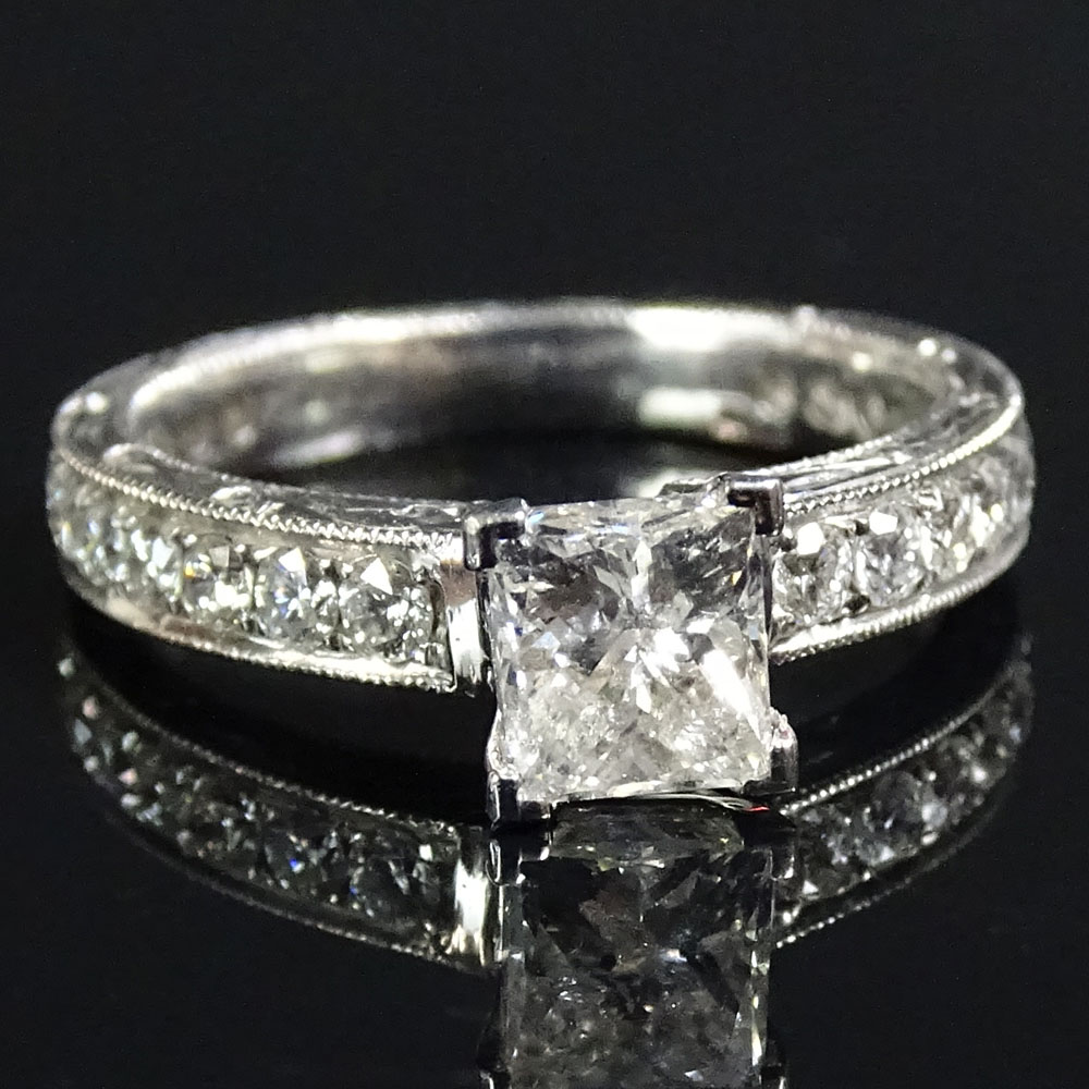 AIG Certified 1.39 Carat Diamond and 18 Karat White Gold Engagement Ring set in the center with a .85 Carat Princess Cut Diamond and accented throughout with .54 Carat Round Brilliant Cut Diamonds.