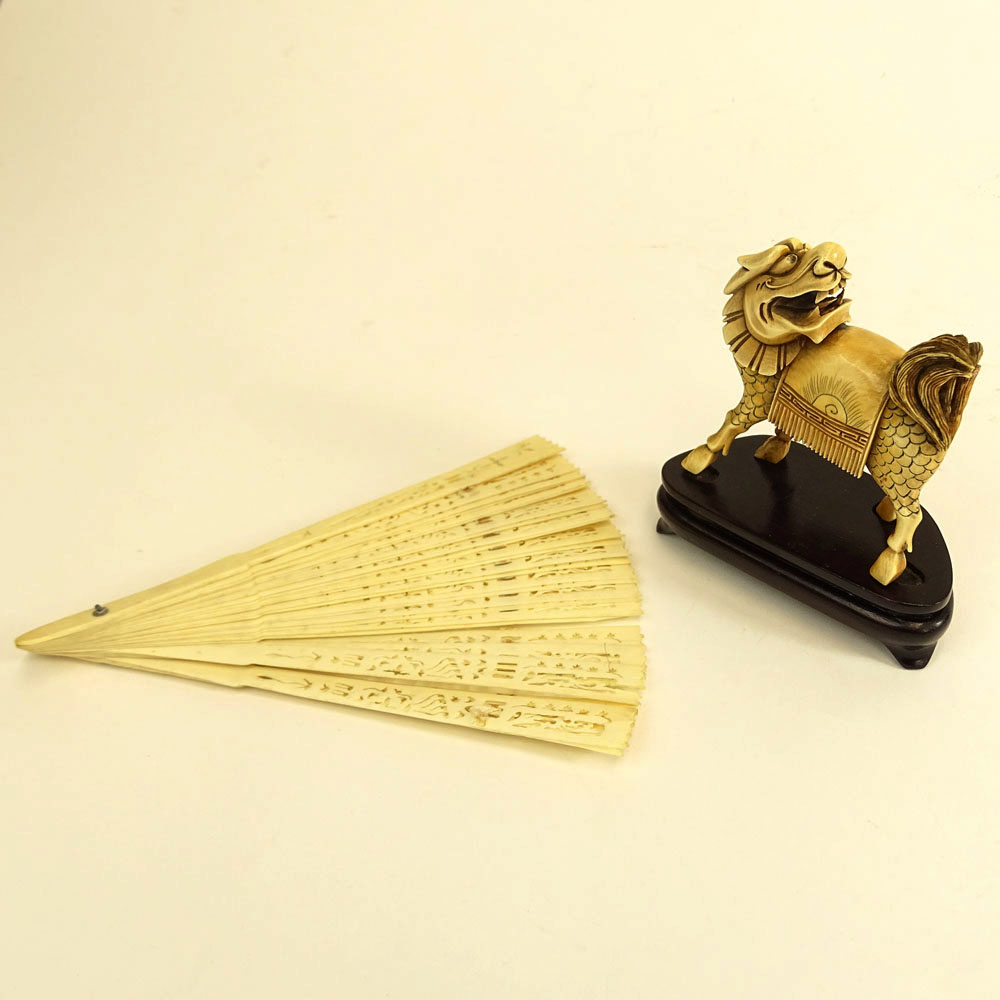 A Vintage Chinese Carved Ivory Mythical Beast Figure and a pierced Ivory Fan.