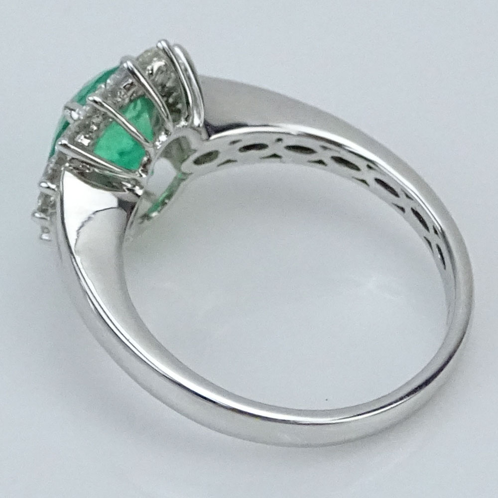 1.63 Carat Oval Cut Emerald, .65 Carat Round Brilliant Cut Diamond and 18 Karat White Gold Ring