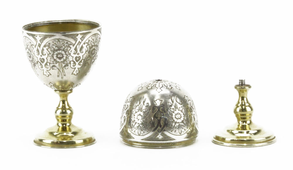 An 1886 Imperial Russian Silver Egg. Engraved with foliate decoration, parcel gilt interior and stands