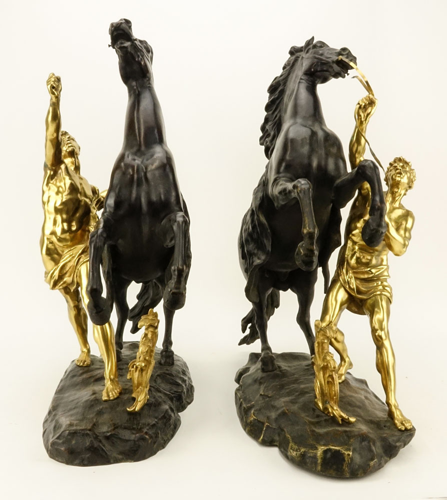 after: Guillaume Coustou the Younger, French (1716-1777) Pair of Patinated and Gilt Bronze Marly Horses. 
