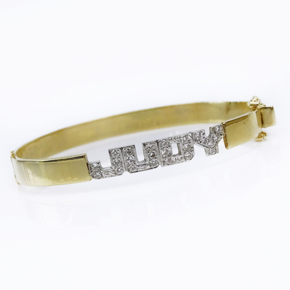 Vintage 14 Karat Yellow Gold Hinged Bangle Bracelet accented with Small Pave Set Diamonds Spelling "Judy". 