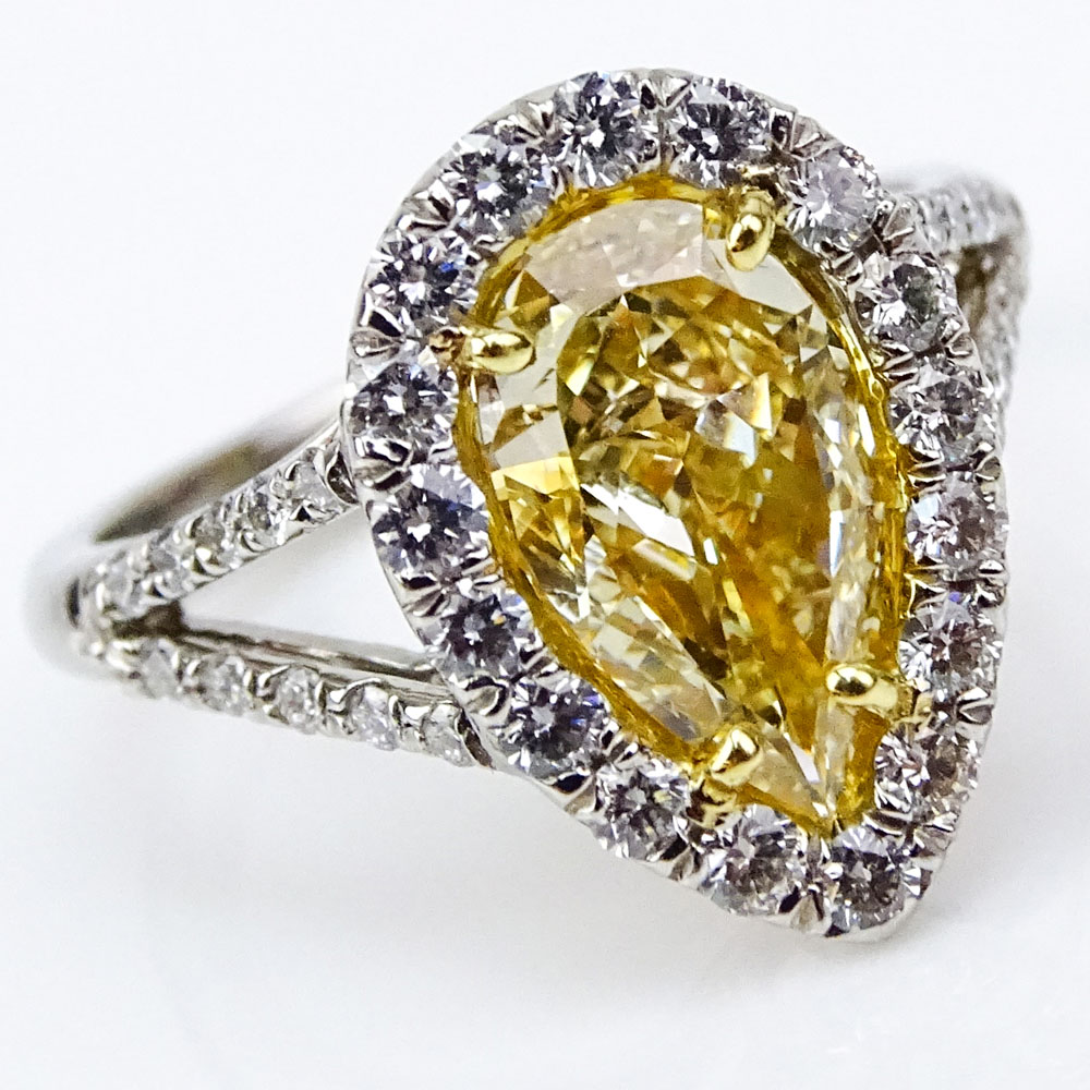 EGL Certified 2.01 Carat Pear Shape Fancy Intense Yellow Diamond and Platinum Ring accented with .71 Carat Round Brilliant Cut Diamonds