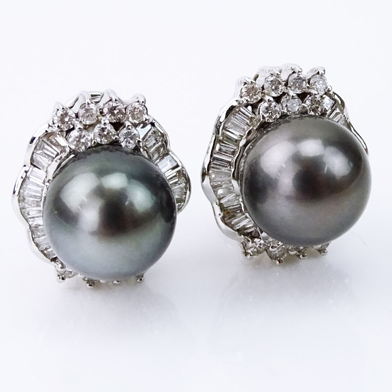 Pair of 11mm South Sea Black Pearl, Baguette and Round Brilliant Cut Diamond and 18 Karat White Gold Earrings. 