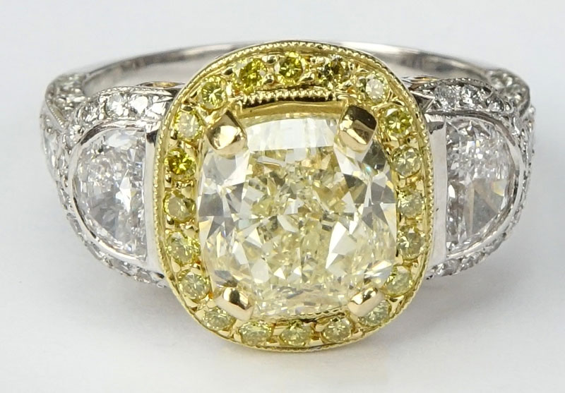 Approx. 3.40 Carat Cushion Cut Fancy Light Yellow Diamond, 1.70 Carat Diamond and Platinum Engagement Ring.