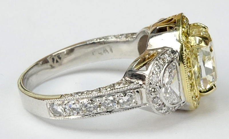 Approx. 3.40 Carat Cushion Cut Fancy Light Yellow Diamond, 1.70 Carat Diamond and Platinum Engagement Ring.