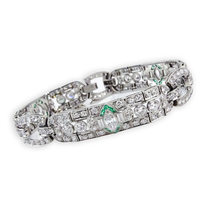 Circa 1920s Art Deco Approx. 11.0-11.50 Carat Old European Cut Diamond and Platinum Bracelet with Colombian Emerald Accents.