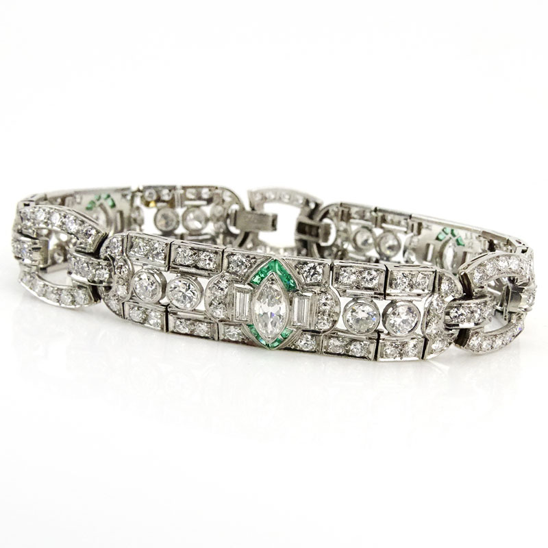 Circa 1920s Art Deco Approx. 11.0-11.50 Carat Old European Cut Diamond and Platinum Bracelet with Colombian Emerald Accents.