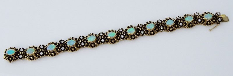Circa 1970s Victorian style Cabochon Opal, approx. 1.0 Carat Round Brilliant Cut Diamond and 14 Karat Yellow Gold Bracelet. Opals with good play of color.
