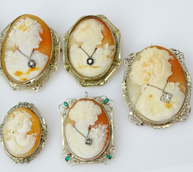 Collection of Eight (8) Art Deco Carved Shell Cameos Variously Bezel Set in White Gold, Silver or Gold Filled Mountings, Six with Small Diamond Accents, One with Emerald Accents