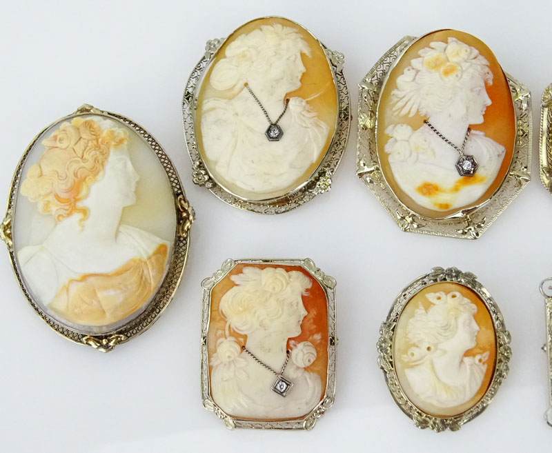 Collection of Eight (8) Art Deco Carved Shell Cameos Variously Bezel Set in White Gold, Silver or Gold Filled Mountings, Six with Small Diamond Accents, One with Emerald Accents